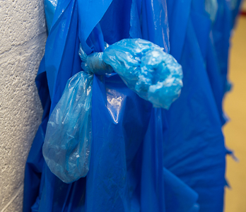 Protective cuffs tied to the PVC apron