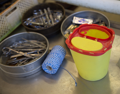 Yellow waste containers for sharps on the table for material