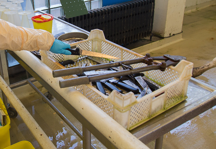 Put dissection instruments back on the table located next to the disinfection zone