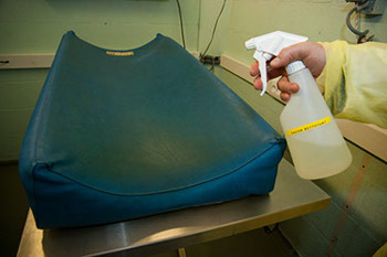 Clean the examination table with soap.