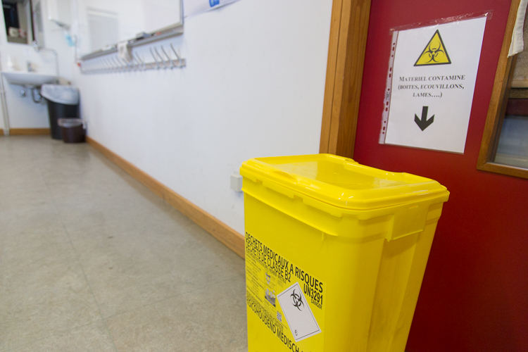 A yellow bin is located to the right of the white board