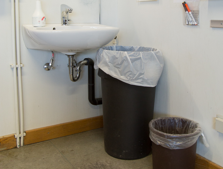 Waste-paper basket next to the  clean  sink