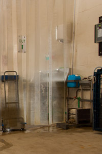 The boot-washing station is located in front of the curtain separating both sides of the anteroom.