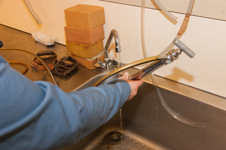 Clean the tubes and other equipment at the sink of the large examination room